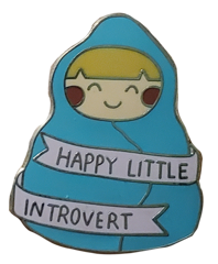 pin of a person in a blanket saying happy little introvert